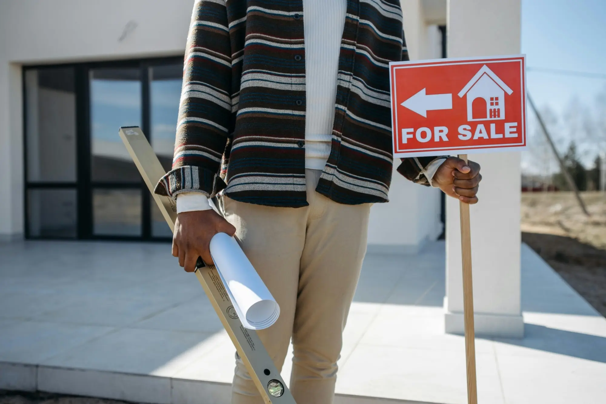 a man holding a sign and a level